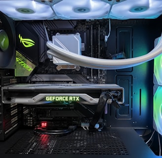 A high-end gaming or performance PC interior equipped with RGB lighting and multiple cooling fans. The graphics card prominently displayed is a GeForce RTX model, with branding visible. The setup includes neatly managed cables and a liquid cooling system.